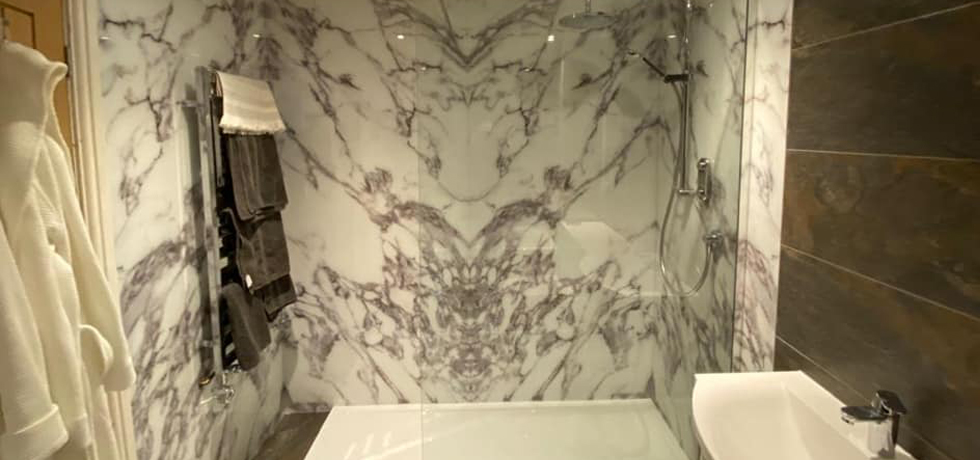 Nuance panels in Carrara Marble fitted by Rothwell Tiles and Bathrooms 